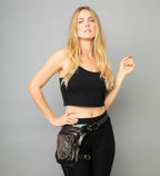 Model standing wearing an Ellko leg belt bag with a hand on her hip